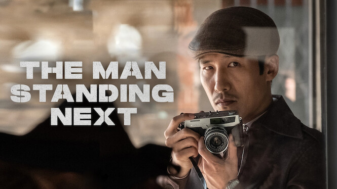 The Man Standing Next